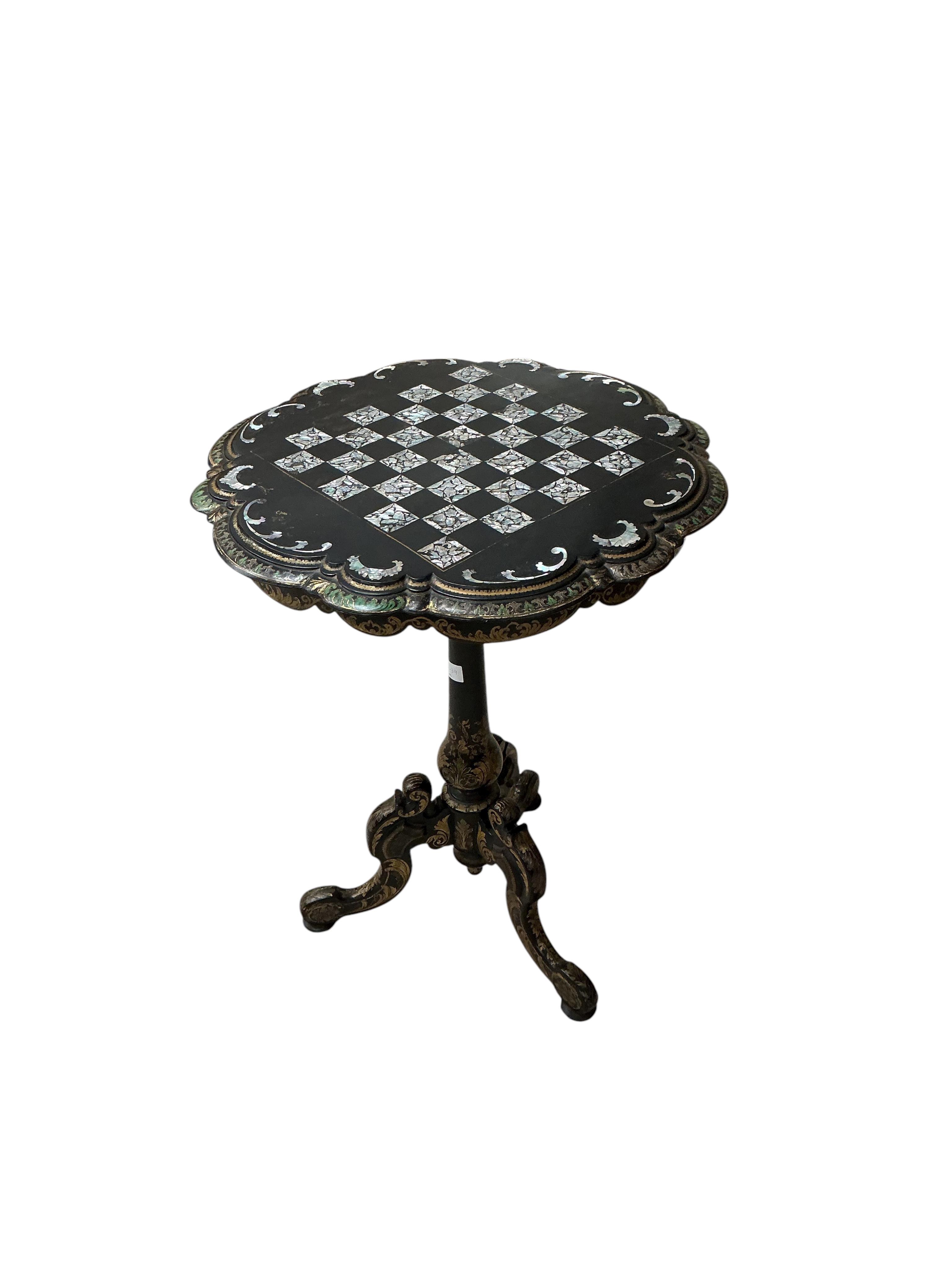 A Victorian mother of pearl inlaid papier mache circular tilt top tripod games table, diameter 56cm, height 74cm